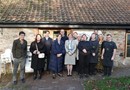 A group of people from Brandon, National Care Forum and Department of Health and Social Care outside Grimsbury Farm Barn Cafe