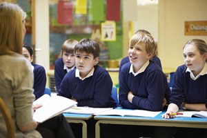 School children looking at their teacher during a lesson