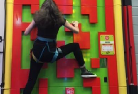 Anna climbing a wall
