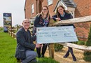 Brandon's fundraising team receiving a cheque from David Wilson Homes