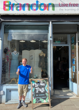 Sam gives the thumbs up outside our Whiteladies Road charity shop