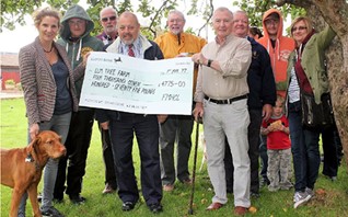 Steve Manning presents cheque to Elm Tree Farm manager Keily Elvin